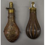 Two 19th century copper and brass powder flasks. The largest 21.5 cm high.