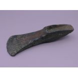 A Bronze Age palstave axe head found in North Norfolk. 15 cm long.