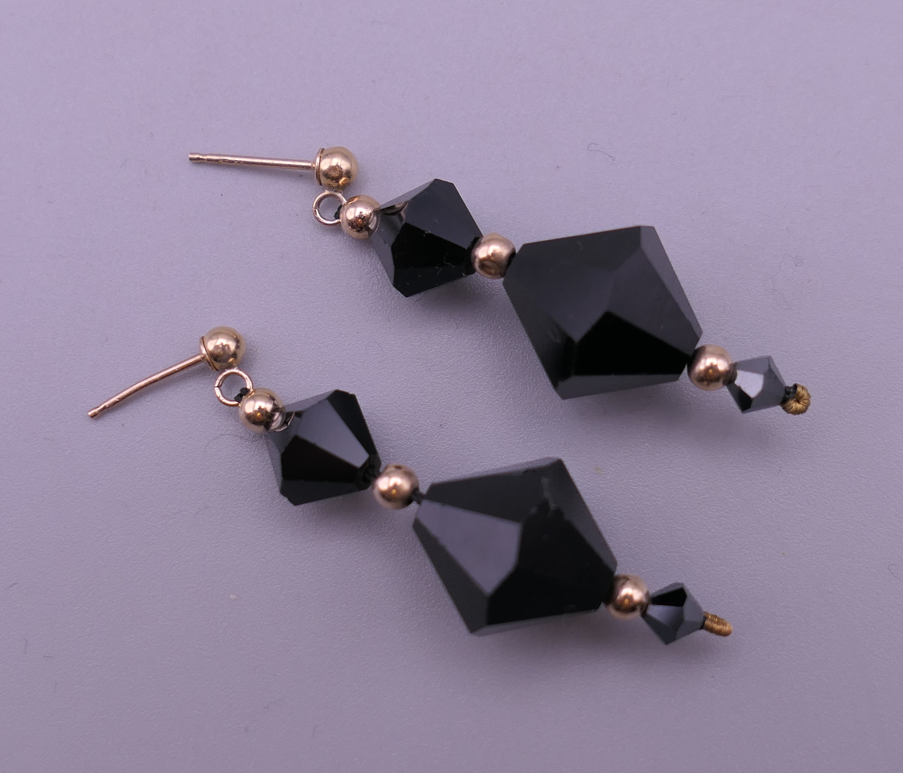 A pair of 9 ct gold mounted Art Deco faceted drop earrings. 3.5 cm high. 5.8 grammes total weight.