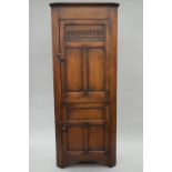 A carved oak standing corner cupboard. 182.5 cm high, 43 cm deep, 74.5 cm wide.