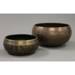 Two Tibetan bronze singing bowls. The largest 15 cm diameter.