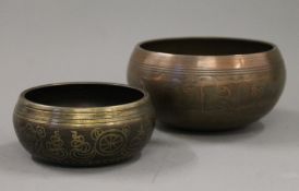 Two Tibetan bronze singing bowls. The largest 15 cm diameter.