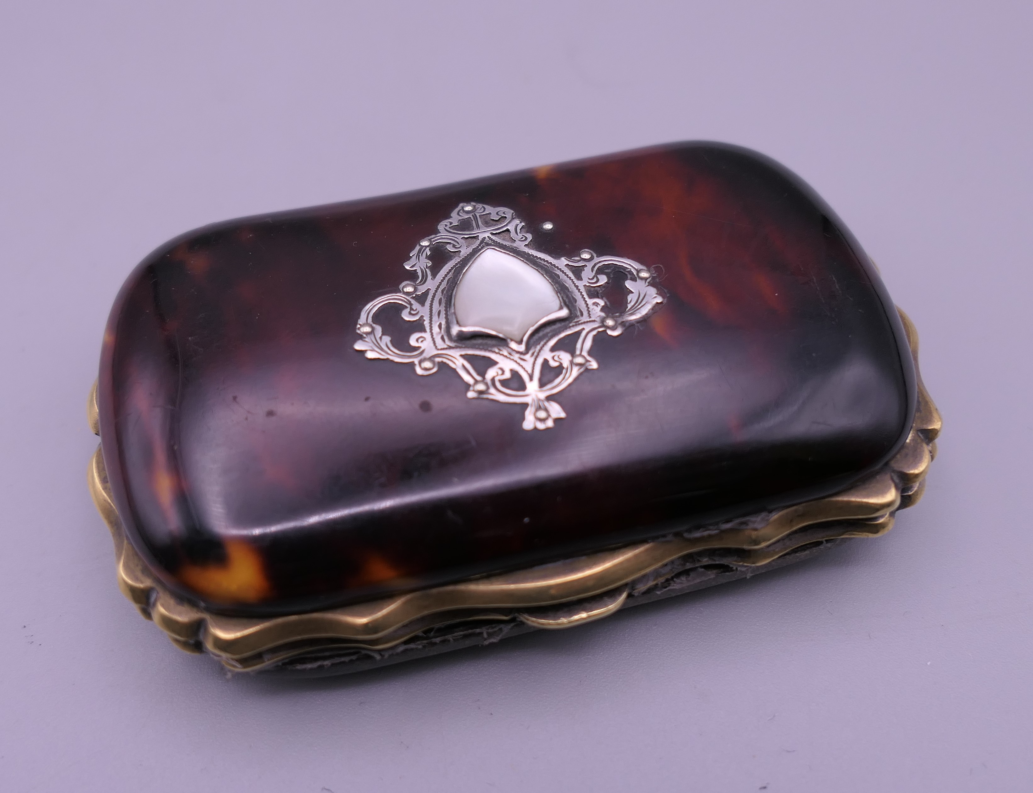 A Victorian silver and tortoiseshell purse lined with silk. 7.5 cm wide.