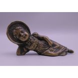 A Victorian bronze figure of a reclining girl wearing a bonnet. 9 cm long.