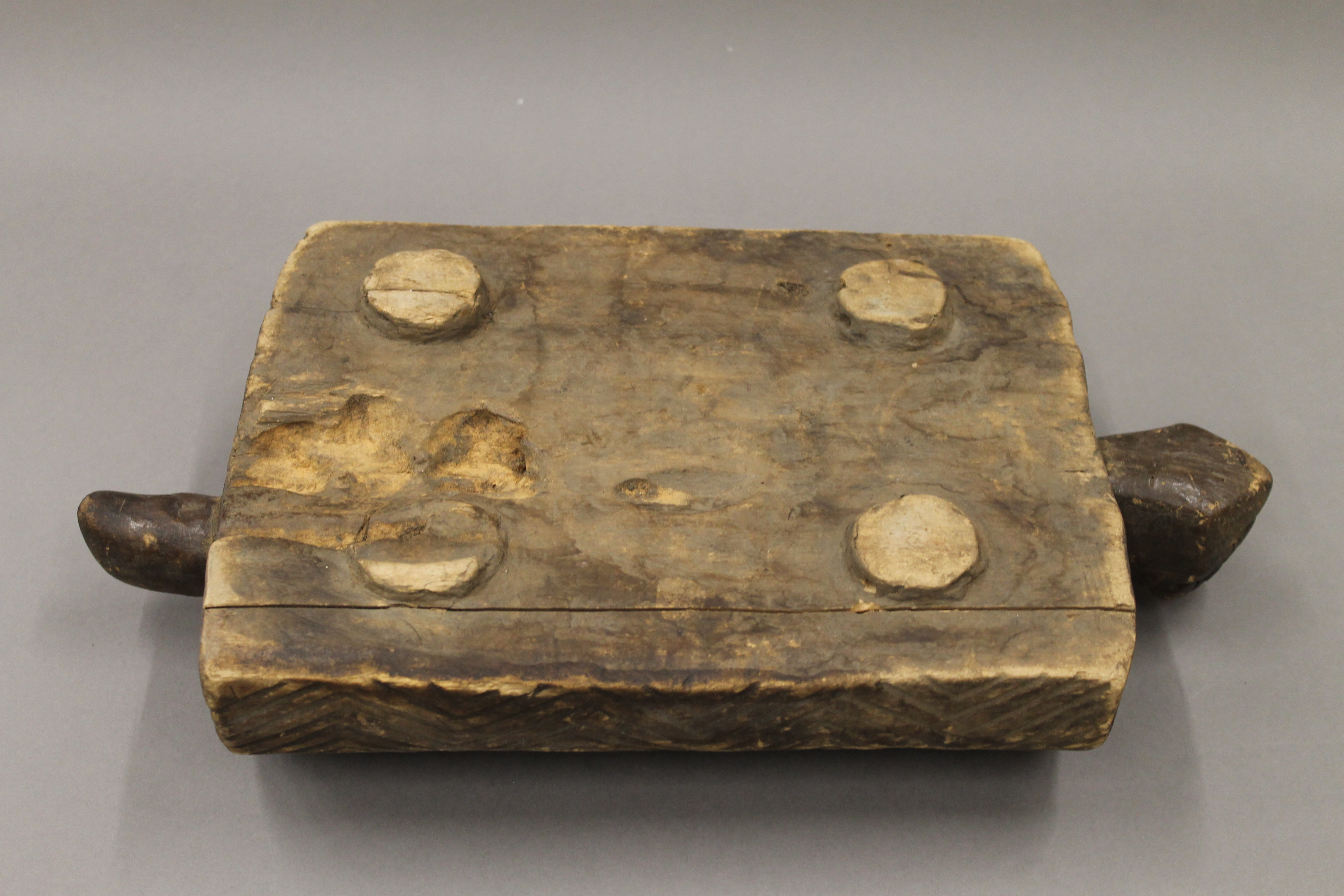 A carved wooden African game board. 40 cm long. - Image 5 of 5