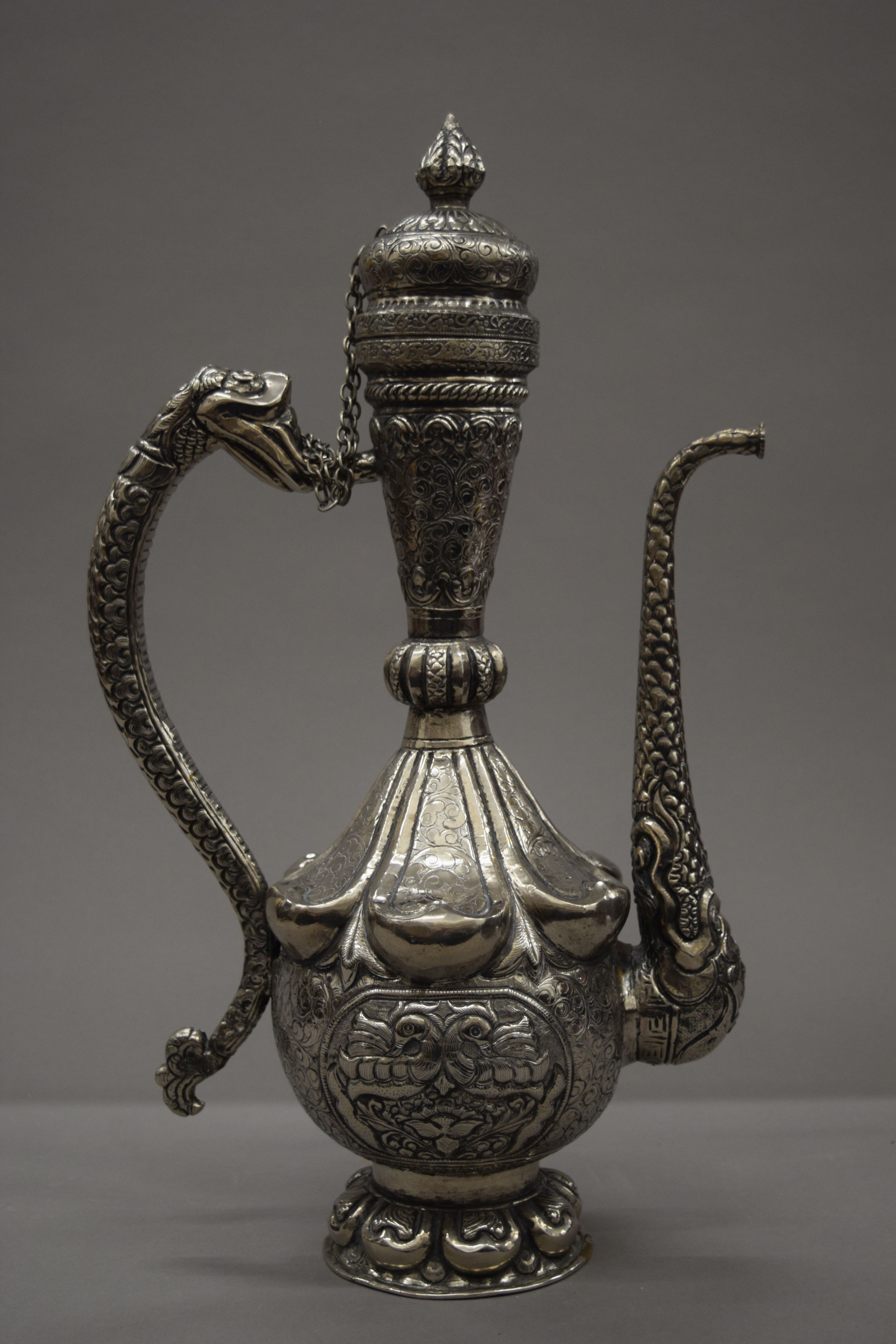 A Tibetan silver on copper repousse decorated ewer. 49 cm high. - Image 2 of 5