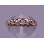 An 18 ct gold diamond five stone ring. Ring size O/P.