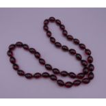 A bead necklace. Approximately 80 cm long.