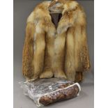 A vintage fur coat and various stoles.
