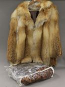 A vintage fur coat and various stoles.