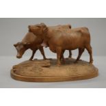 A Blackforest carved model of two cows. 13 cm high.