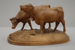 A Blackforest carved model of two cows. 13 cm high.