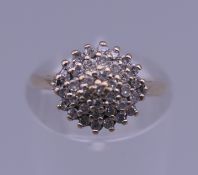 A 9 ct gold diamond cluster ring. 1/4 carat diamond weight. Ring size I/J. 2 grammes total weight.