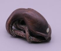 A carved wooden netsuke formed as an octopus. 5 cm long.
