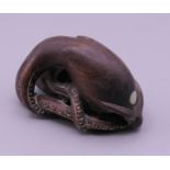 A carved wooden netsuke formed as an octopus. 5 cm long.