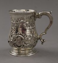 A Georgian silver tankard with later embossed decoration. 10 cm high. 221.8 grammes.