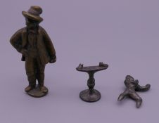 A 19th century brass pipe tamper and another pipe tamper formed as a boxer (AF).