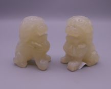A pair of carved hardstone Chinese temple lions. 6 cm high.