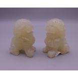 A pair of carved hardstone Chinese temple lions. 6 cm high.