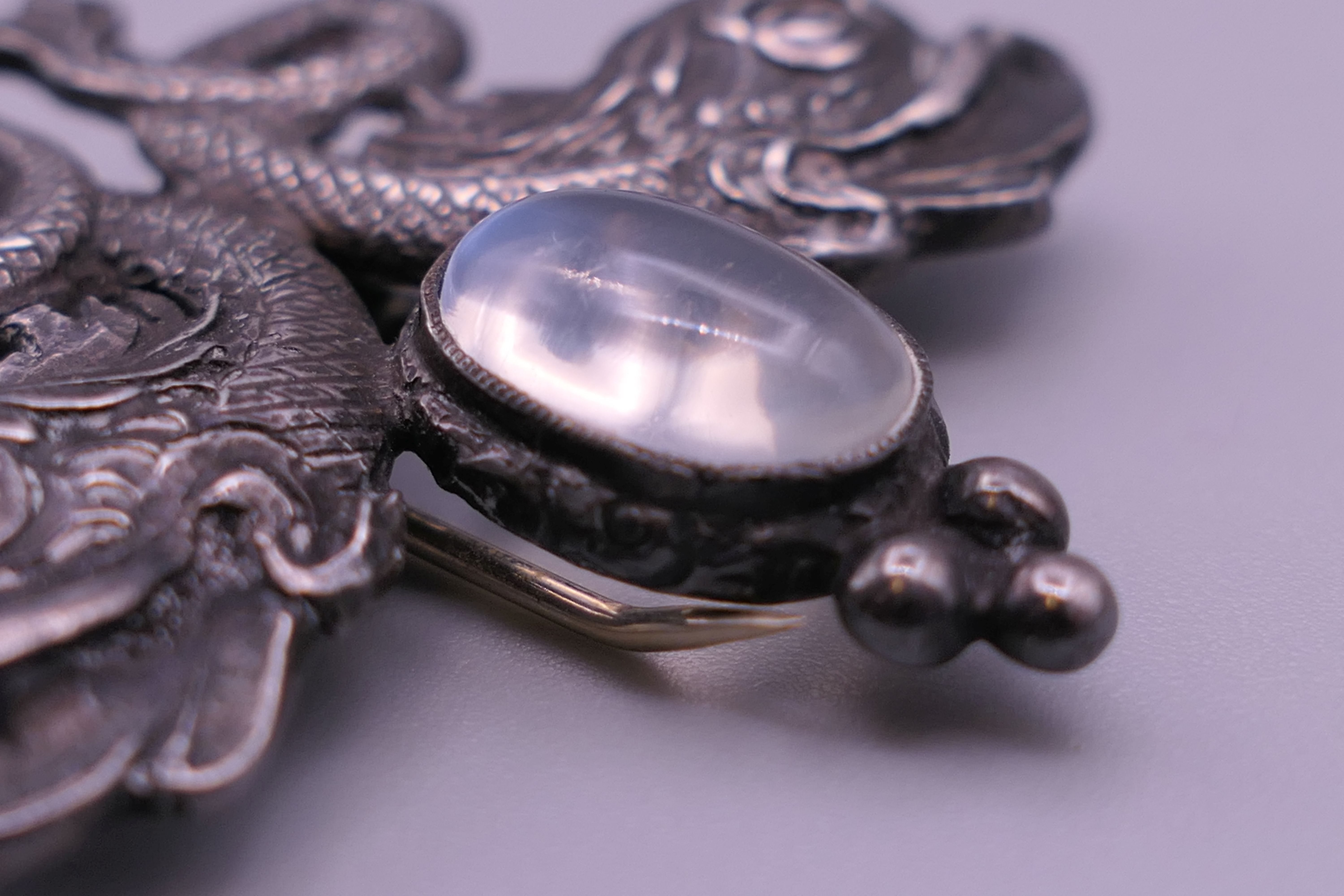 A silver and moonstone dolphin brooch. 4 cm wide. - Image 5 of 5