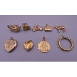 A quantity of various gold charms and lockets.