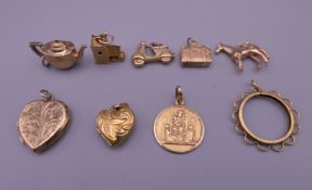 A quantity of various gold charms and lockets.