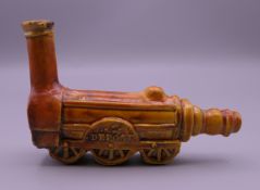 A 19th century French pottery pipe formed as a steam train. 7 cm long.