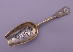 An enamel decorated silver gilt spoon bearing Russian marks. 13 cm long.
