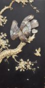 A 19th century Japanese lacquered panel set with bone and mother-of-pearl depicting an eagle on a