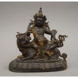 A bronze model of Buddha seated on a dog of fo. 18.5 cm high.