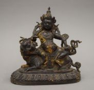 A bronze model of Buddha seated on a dog of fo. 18.5 cm high.