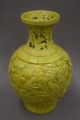 A Chinese olive green vase of reticulated form with Qianlong seal mark to base and decorated with