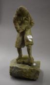 An unusual sculpture of a man holding a baby mounted on a granite base. 38 cm high.