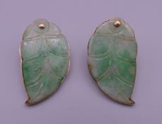 A pair of gold and jade earrings. 3 cm high.