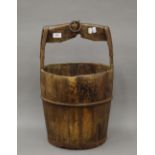 An antique Chinese wooden well bucket. 56 cm high.