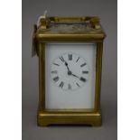 A brass cased carriage clock, with key. 17 cm high.