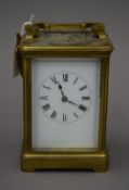 A brass cased carriage clock, with key. 17 cm high.