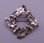 A silver oak leaf and acorn brooch. 3 cm diameter.