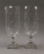 A pair of cut glass storm lamps. 34 cm high.