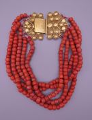 A coral bead necklace with an 18 ct gold clasp. 37 cm long.