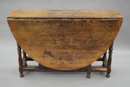 An 18th century oak gate leg table. 120 cm deep.