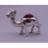 A sterling silver camel form pin cushion. 3 cm high.