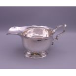 A silver sauce boat. 19 cm long, 10 cm high to top of handle. 315.6 grammes.