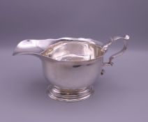 A silver sauce boat. 19 cm long, 10 cm high to top of handle. 315.6 grammes.
