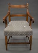 A 19th century upholstered elm open arm chair. 51.1 cm wide.