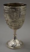 A large extensively embossed Indian silver trophy cup, the base stamped Cooke & Kelvey Calcutta. 26.