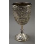 A large extensively embossed Indian silver trophy cup, the base stamped Cooke & Kelvey Calcutta. 26.