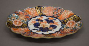 A 19th century Imari porcelain scallop dish, the underside signed. 20.5 cm long.