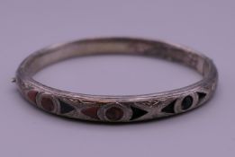 A Victorian Scottish white metal (silver) hardstone/agate engraved bangle. 6.5 cm wide. 11.