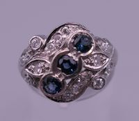 An 18 ct white gold diamond and sapphire ring. Ring size L.